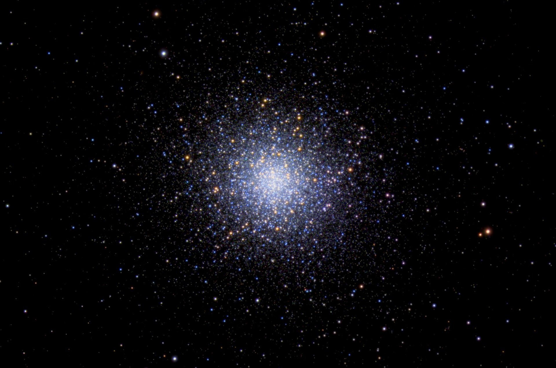 A stunning view of a globular cluster filled with bright stars against a dark cosmic background.